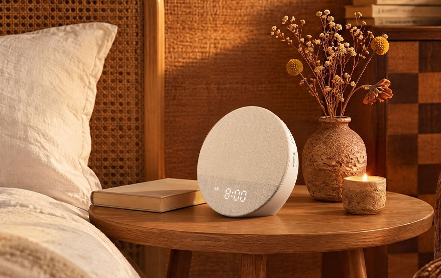 Dreamegg Sunrise 1 with a fabric front and digital display on a wooden bedside table