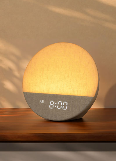 Front view of a Dreamegg Sunrise 1 glowing above its digital clock display